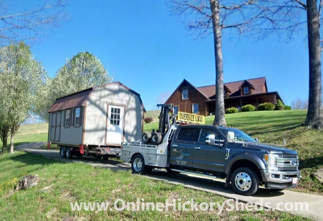 A Hickory Shed being towed by a house